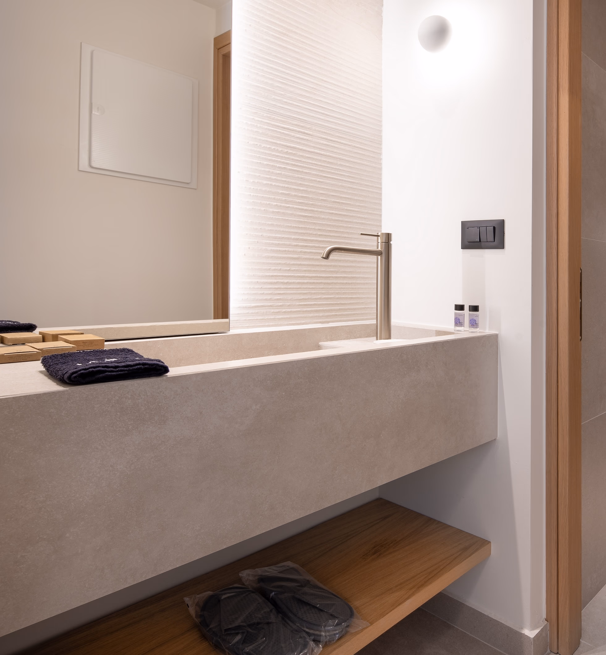 Minimalist bathroom with warm wood and concrete